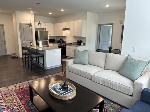 Open concept living area with Arhaus sofa