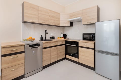 A fully equipped kitchen with wooden cabinets, modern appliances, and ample workspace.