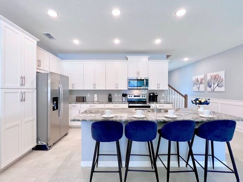 Cook with ease in the open-concept kitchen featuring modern stainless steel appliances, generous workspace, and a layout perfect for gathering with family and friends.