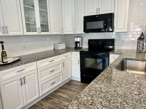 Our kitchen is equipped with cookware and plenty of dishes and serving pieces.