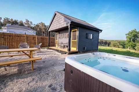 Outdoor dining area, living area, and hot tub