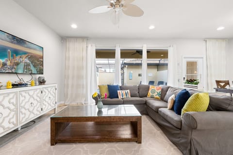 Gather in the inviting living room with comfortable furnishings, a large flat-screen TV, and complimentary high-speed Wi-Fi for entertainment and relaxation.