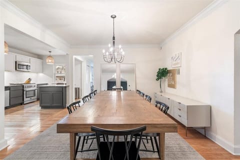 Open concept dining room and kitchen with a table that seats 10 + 2 bar stools.