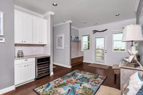 bar off the dining area with a wine cooler