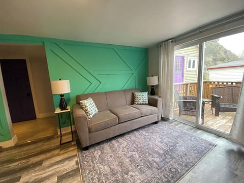Indulge in relaxation in the living room, complete with a TV and a serene private balcony
