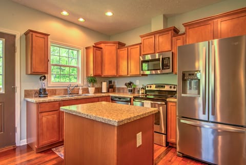 You won't find this kitchen area lacking. Fit with a fridge, microwave, oven/stovetop, and an island to boot!