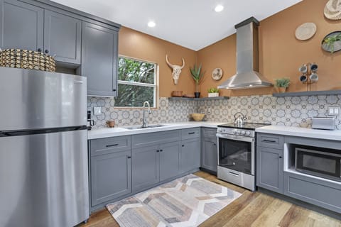 The cabin has a modern kitchen with stainless range/oven combo.