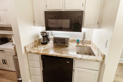 Kitchenette with toaster oven, coffee machine, mini fridge and large microwave