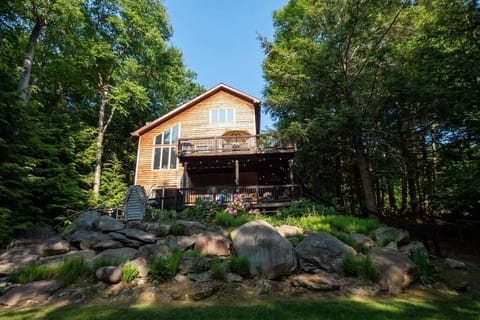 Chalet sits perched on the ridge with dramatic views of the lake and backyard