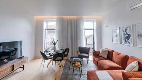 Spacious living area with a large, comfortable sofa, dining table, TV, and abundant natural light flowing in from the balcony.
#comfort