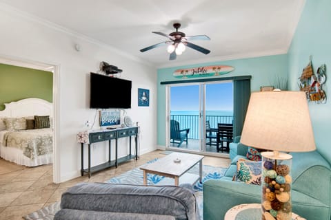 Living room sleeper sofa, 2 end tables, coffee table 2 arm chairs, ceiling fan and a 55" wall mounted Smart TV and a great direct Gulf view