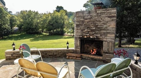 Outdoor wood fireplace and spacious backyard at A Mountain Cottage — perfect for BBQs, social evenings, and Smoky Mountain memories