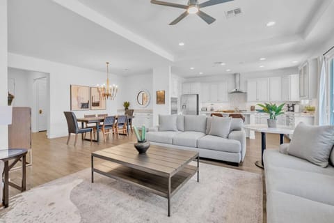 View of home`s open floor plan with kitchen, living, and dining areas, all with thoughtful and beautiful decor, ready for you to enjoy