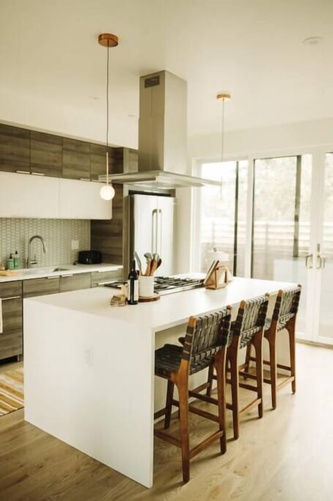 The waterfall countertop can accommodate your work laptop and a breakfast bar for three.