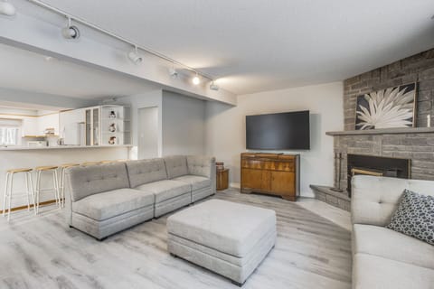 Spacious open-concept living room with a cozy fireplace and modern finishes.