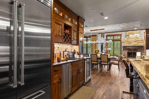 Whip up a meal in this fully-equipped kitchen, featuring a large island with bar seating, granite countertops, and modern amenities.
