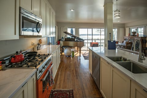 Kitchen overlooking lake with adjoining terrace.  Dining 10 at table & 3 @ bar