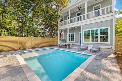 Relax in this backyard pool oasis with built in grill