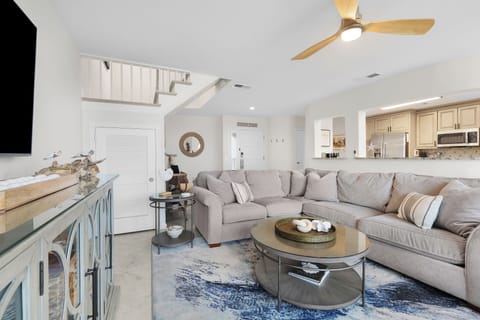 Gorgeous Oceanfront Living Space with Comfortable Sectional Sofa, Two Swivel Glider Chairs and Flat Screen Smart TV