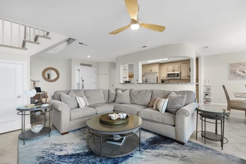 Gorgeous Oceanfront Living Space with Comfortable Sectional Sofa, Two Swivel Glider Chairs and Flat Screen Smart TV