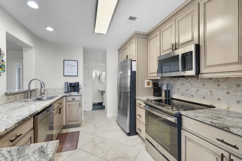 Totally Renovated Kitchen with Granite Countertops and Stainless Steel Appliances - Kitchen is Open to Living and Dining Spaces