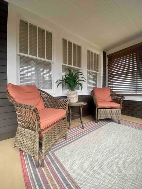 Youโll be greeted by a charming enclosed porch with seating to relax and enjoy the quiet neighborhood with privacy.