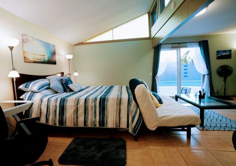 Spacious suite w/ vaulted ceilings + views of pool, garden & patio.