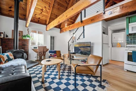 Living area open to kitchen. 55' smart tv, electric fireplace, ceiling fan.