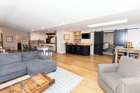 Your open-concept haven blends rustic charm with modern comfort—relax on plush seating while dinner simmers in the sleek kitchen.