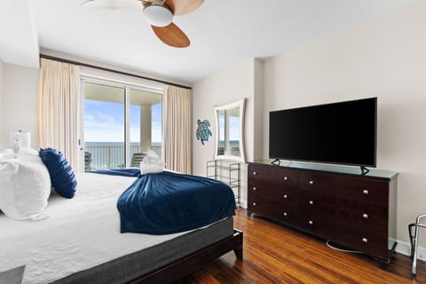 The room is finished with a TV and dresser, providing storage and entertainment.