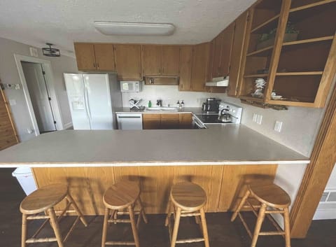 Four bar stools in addition to dining room table that seats six