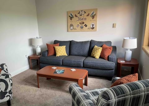 Comfy living room with tons of natural light is perfect for reading or visiting