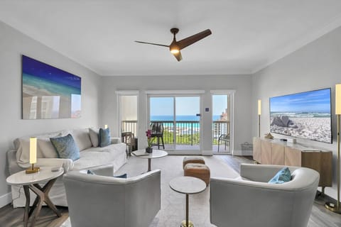 Sleek beach condo living room: modern furnishings, stunning ocean vista. Coastal chic at its finest. #RelaxationMode