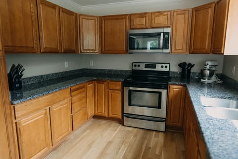 Kitchen utensils, kitchen aid mixer, electric stove, pots and pans included