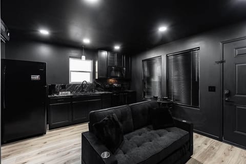 Couch in living room and kitchen