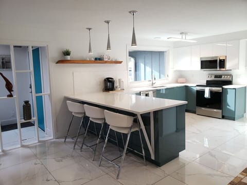 Kitchen with island seating for 3, lots of daylight, and spacious enough for lots of chefs and great entertainment