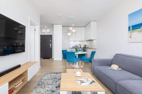A full shot of the open-concept living space leading into the kitchen, emphasizing modern design.