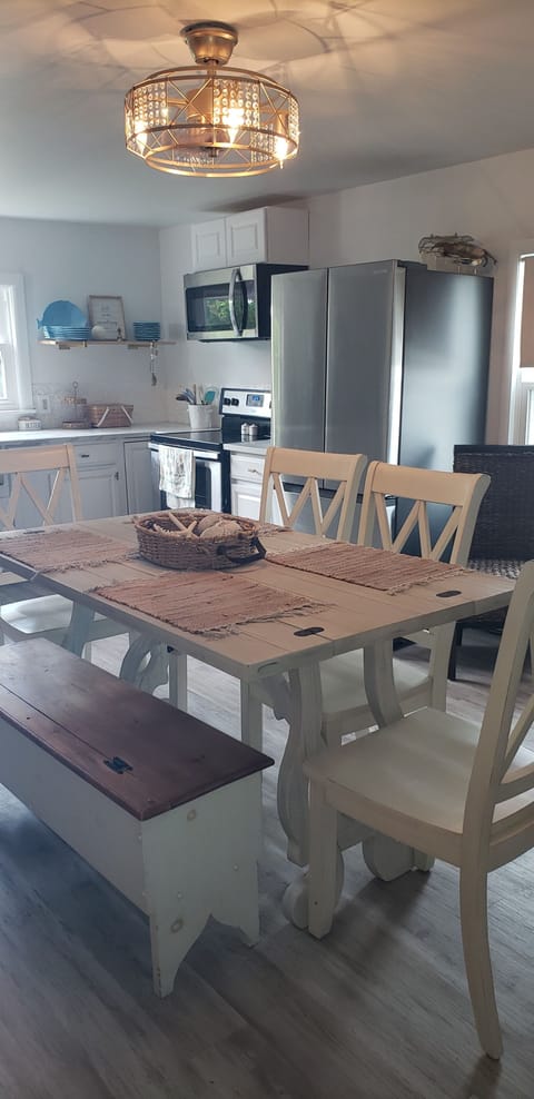 Family Style Dining Table. Modern Stainless Steel Refrigerator.
