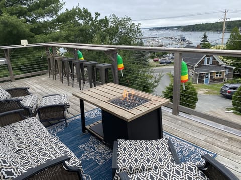 Deck furniture, railing bar top, and outdoor fire pit for enjoying the views