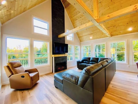 Great room with leather sectional, rocker recliner, electric fireplace, and 55 inch smart TV with Chromecast