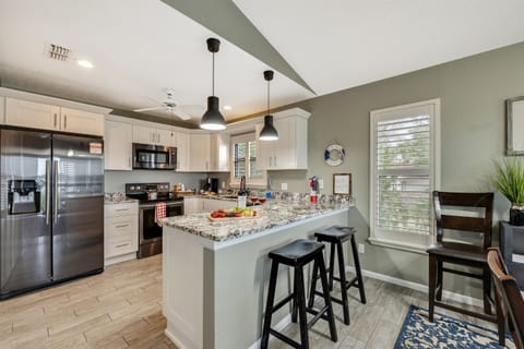 The white cupboards provide ample storage space for your culinary needs, ensuring that everything is within reach.