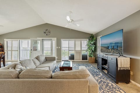 Positioned strategically, this inviting seating arrangement faces a generously sized smart TV, promising endless entertainment and relaxation.