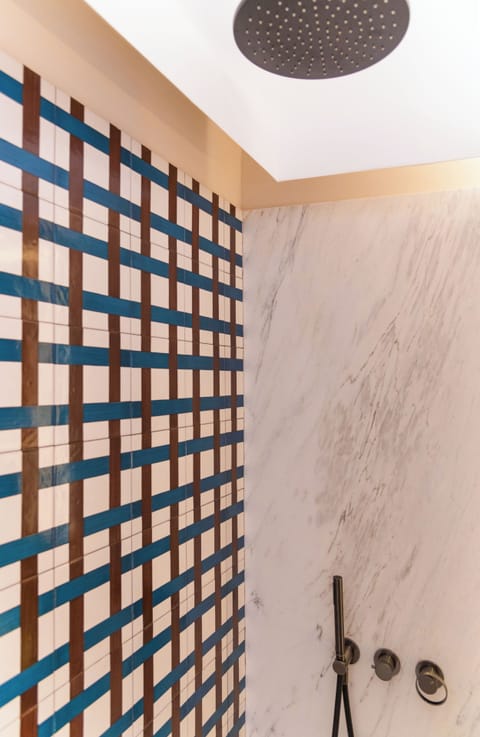 Deluxe Quadruple Room | Bathroom | Rainfall showerhead, eco-friendly toiletries, hair dryer, bathrobes