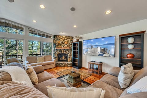 Relax and recharge in this light-filled home where you will find soaring windows and a spacious deck overlooking the surrounding trees.