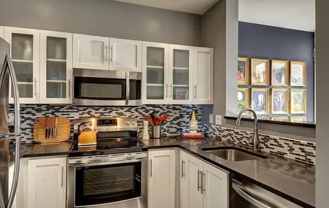 Gourmet kitchen with newer cabinets, quartz counters and Stainless-Steel appliances.