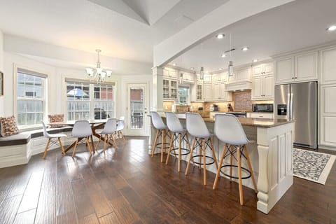 At the far end, you'll see a second dining area with bench seating and four chairs.