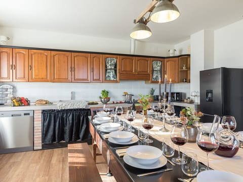 Countertop, Property, Cabinetry, Furniture, Table, Kitchen, Lighting, Dishware, Wood, Interior Design