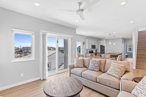 The open living area with a Smart TV and balcony access