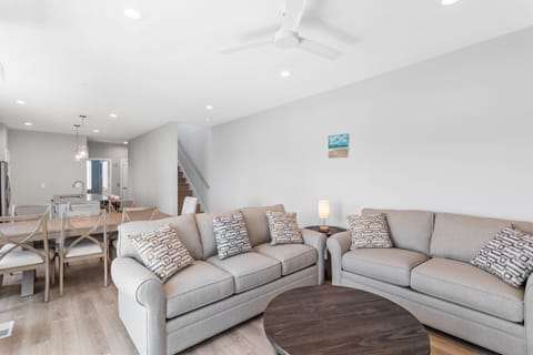 The open living area with a Smart TV and balcony access
