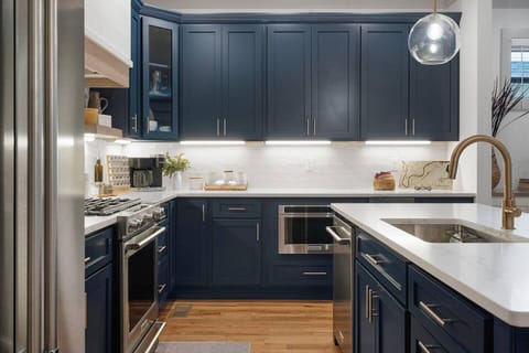 The kitchen has ample counter space, KitchenAid appliances, and a separate under counter ice maker.